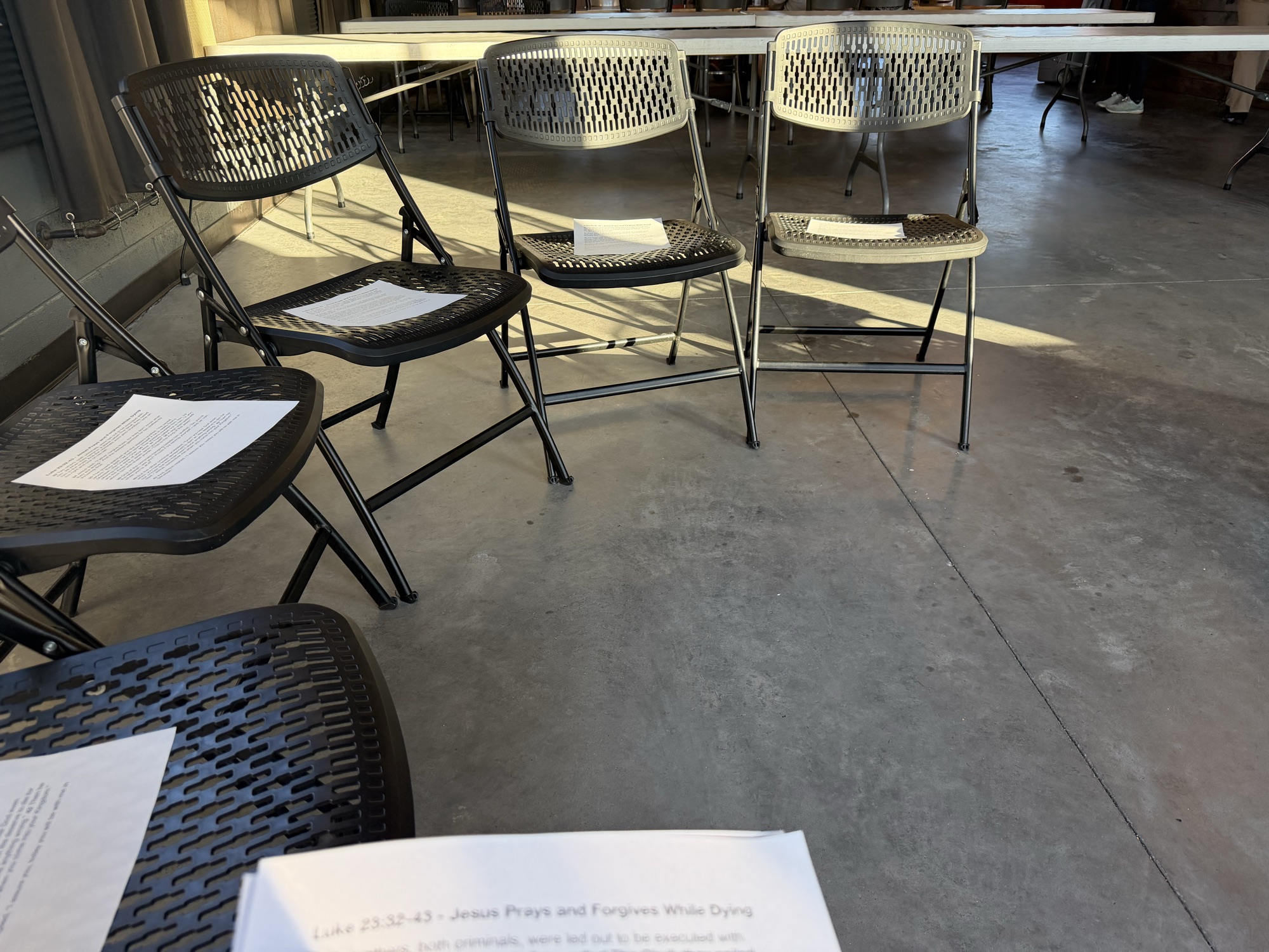 Study sheets set out on chairs before a Discovery Bible Study session